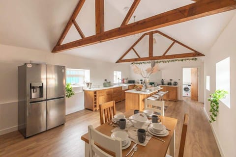 Cook up a storm in this charming barn-inspired kitchen, featuring warm wooden finishes, modern appliances, and plenty of counter space. The perfect blend of rustic character and contemporary convenience makes every meal feel cozy and inviting.