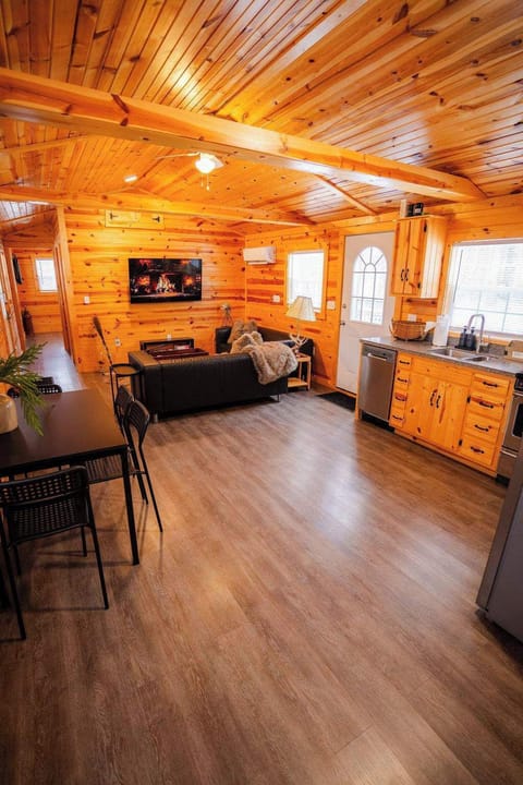 Living Room: Embrace the charm of wood accents, modern comfort, and playful vibes in this bright space!