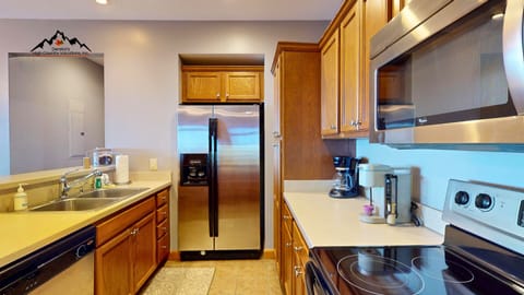 Your fully equipped kitchen features stainless steel appliances, warm wood cabinetry, and granite countertops—perfect for preparing meals during your stay.