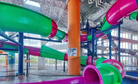 Water slides wrap around a central orange support pillar for safety.