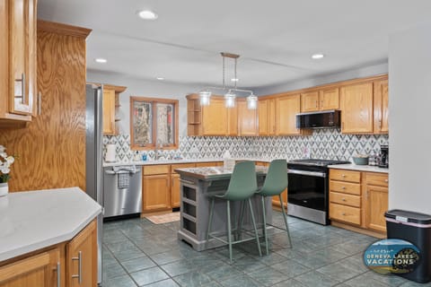 Full kitchen with island, stove, microwave, dish washer and refrigerator