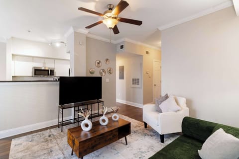 Spacious open-concept living room with smart TV for entertainment & comfort.