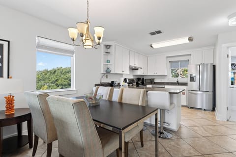 Gather for meals and game nights at the spacious dining table—steps from the kitchen for easy serving.