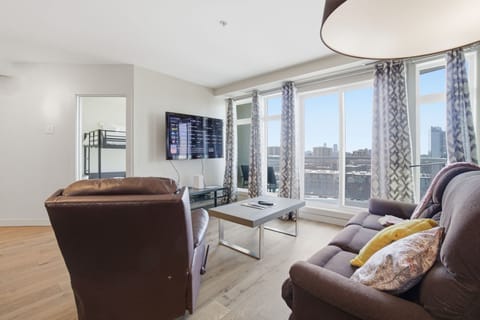 Relax with a wall-mounted smart TV and cozy seating, perfect for streaming your favorite shows.