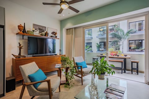 Relax in your stylish living area with modern furniture, ceiling fan, and bright patio access for seamless indoor-outdoor flow.