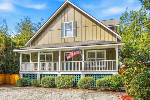 Covered Front Porch on Ocean View - Classic St. Simons cottage with a deep covered front porch and elevated design. A short walk toward the King and Prince area and the beach beyond.