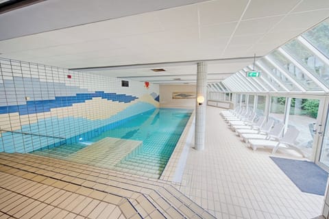 Dive into a sunlit indoor pool for effortless relaxation.