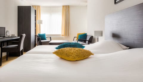 Relax in a spacious room with lounge seating and desk.