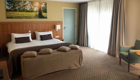 Unwind into plush bedding in a bright, quiet room.