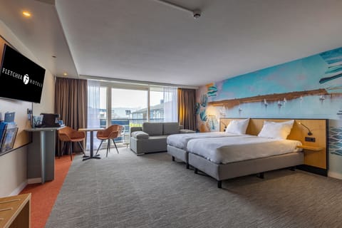 Unwind in a bright suite with beds, sofa, and balcony views.