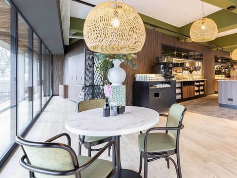 Sip coffee by sunlit windows in a calm dining nook.