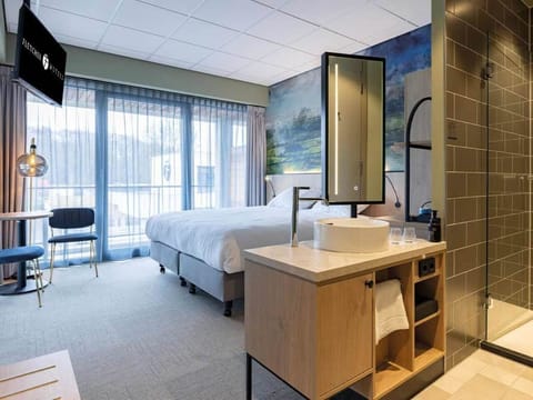 Unwind in a bright suite with spa-style open bathroom.