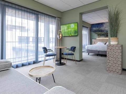 Unwind in a bright suite with balcony-style windows.