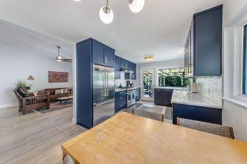 Navy cabinetry and gold accents anchor this open kitchen.