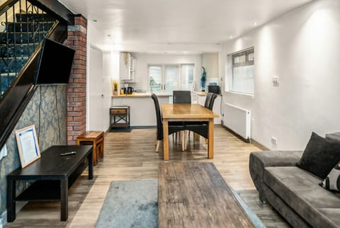 Open-plan living flows from the lounge through dining to the fully equipped kitchen.