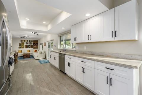 Bright open-concept design featuring sleek cabinetry, dining space, and cozy seating.