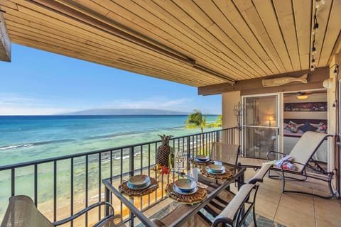 Cozy oceanfront lanai dining with uninterrupted views of turquoise waters