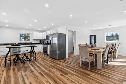 Bright open-concept kitchen + dining—perfect for group meals, game nights, and gathering together.