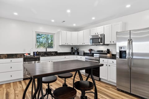 Bright, fully equipped kitchen with stainless appliances and a roomy island—perfect for cooking, snacking, and gathering.