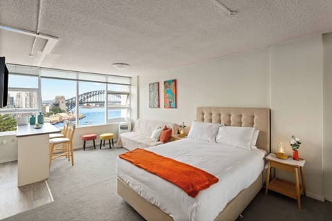 The sleeping area features a queen bed, mirrored wardrobes and soft natural light.