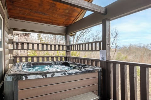 Soak in your private hot tub while enjoying peaceful forest views from this covered deck.