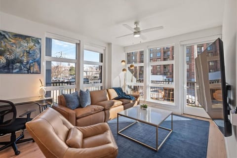 Beautifully designed living room with plenty of light from it`s large windows. Leather couch and recliner. 75`TV. Local Art.