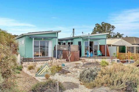 The exterior of the home showcases striking architectural lines, native gardens and an absolute waterfront position that immediately sets the holiday tone.