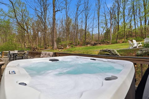 Spacious outdoor deck perfect for enjoying the hot tub and wooded views.