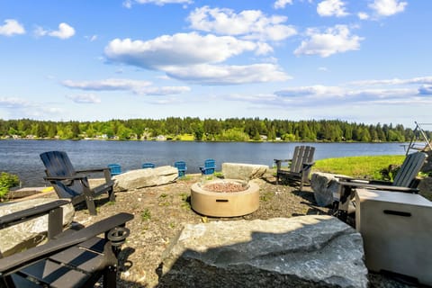 Fire pit (propane) surrounded by adirondack chairs offer you a memorable time