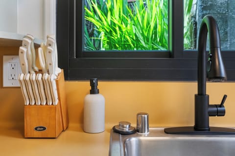 Greenery just outside the kitchen sink—fresh, natural views.