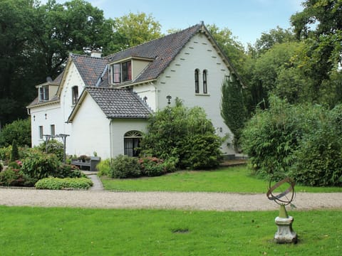 Stroll past charming outbuildings framed by greenery and quiet lanes.