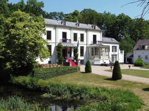 Breathe in serene pond views with the manor beyond.