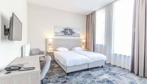 Stretch out in a sunlit room with cozy twin beds.