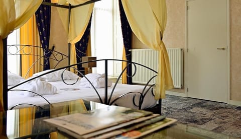 Wake up in soft light beside your airy canopy bed.