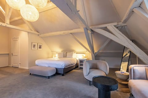 Unwind beneath rustic beams in a serene king bed.