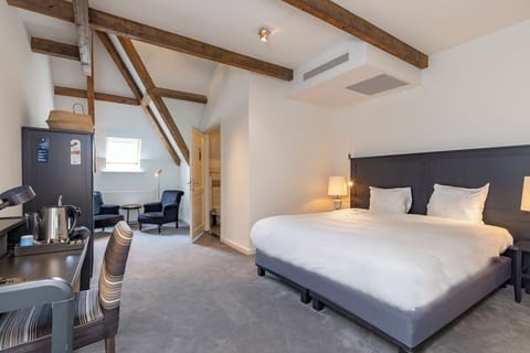 Stretch out in a modern suite with coffee and seating nook.
