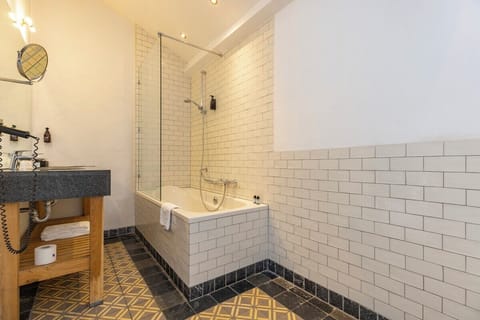 Rinse off comfortably in the spacious glass-walled shower.
