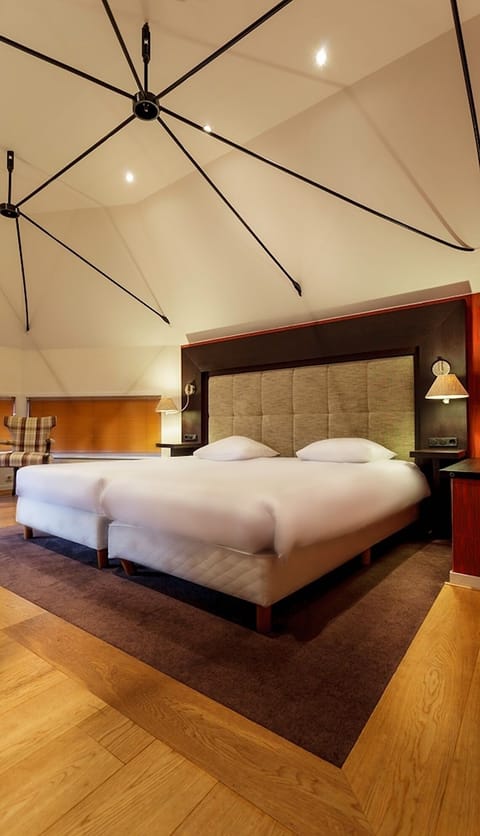 Unwind beneath soaring ceilings in a plush, serene bed.