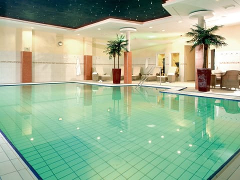 Dive into a serene indoor pool under soft lights.