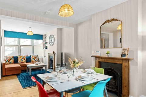 Bright open-plan living area with cosy sofa seating and large windows flooding the space with natural light