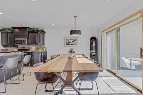 Gather around this elegant dining table where memorable meals await. Your open-concept space flows seamlessly between kitchen and dining areas.
