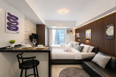 Spacious modern studio with comfy bed, cozy sofa, dining area, and natural light—perfect for couples, friends, or business travelers.