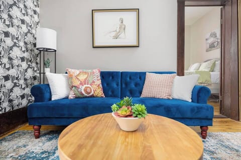 The living room has a sofa that folds down into a large twin bed