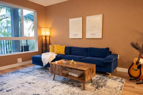 
Spacious living room featuring a cozy L-shaped sofa, a full-size air mattress, and a 65" Smart TV with preloaded access to Netflix, Hulu, and Disney+, all set up for your enjoyment.