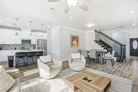Light-filled great room with easy flow from kitchen to dining and lounge.