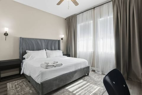 Serene bedroom with a plush king bed, soft linens, and natural light—designed for restful nights and a comfortable, relaxing stay.