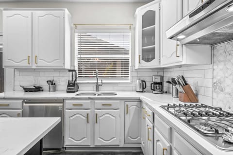 Well-stocked kitchen with modern appliances, cookware, and everything needed to prepare meals comfortably.
