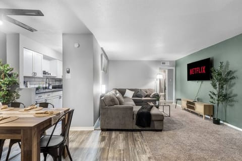 Spacious and inviting living area with comfortable seating and a smart TV, perfect for relaxing after exploring Arlington or attending events at AT&T Stadium.