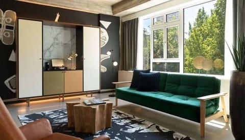 Stretch out on the plush sofa in a bright, stylish lounge.