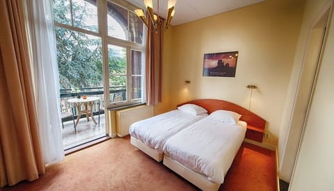 Enjoy a classic, comfortable room with high ceilings and calm tones.